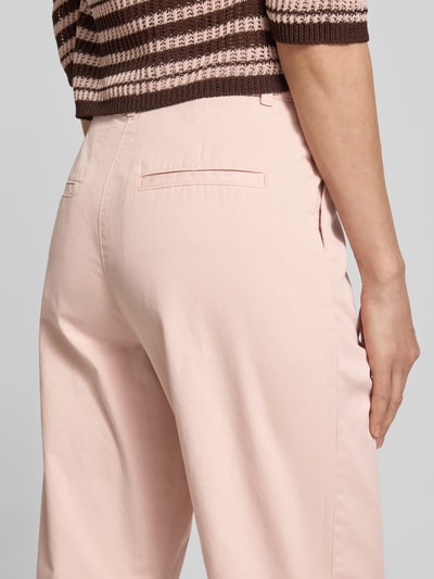 Frauenmodel trägt Chino mit Paspeltaschen am Gesäß von Jake*s Casual in zartem Rosa, glatte Textur, seitliche Eingrifftaschen, Nahaufnahme Rückansicht, Relaxed-Fit, verkürzte Passform, Bundweite Größe 36: 37 cm, Innenbeinlänge 68 cm.