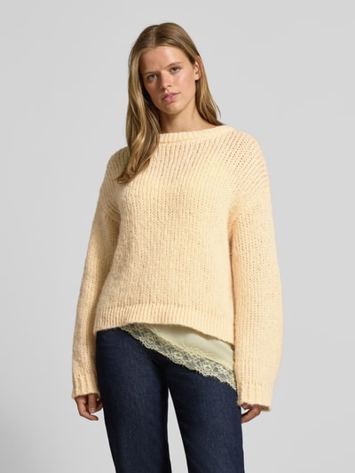 Frauenmodel trägt cremefarbenen Relaxed Fit Pullover im Chunky Knit Look Modell 'DORTHEA' von PIECES, Damen Pullover, Ganzkörperansicht von vorne.