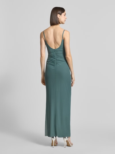 Frauenmodel trägt Slim Fit Abendkleid mit Raffungen von Jake*s Cocktail aus Elastischer-Material-Mix in Grün, Rückenreißverschluss, Spaghettiträger, Ganzkörperansicht Rückansicht. Rückenlänge bei Größe 36: 128 cm, Brustweite bei Größe 36: 41 cm.