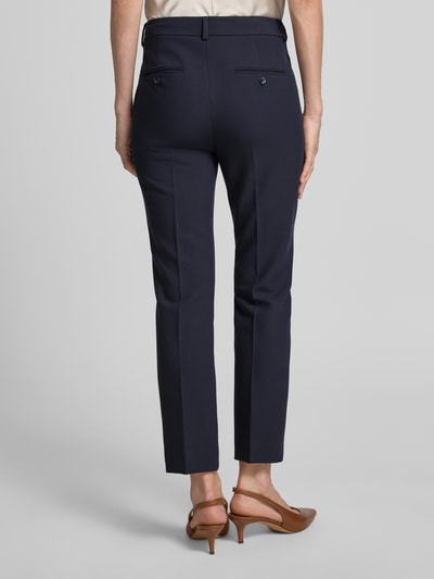 Vrouwenmodel draagt Slim Fit Bundfaltenhose met Viskose-Anteil Modell 'RANA' van Weekend Max Mara in effen donkerblauw webmateriaal, high waist, steekzakken, achterzakken, label stitching detail, detailopname rugaanzicht.