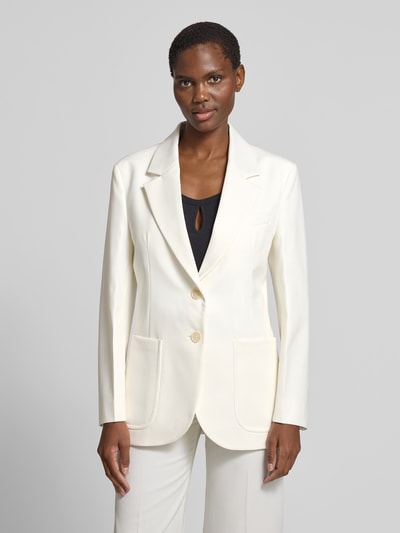 Frauenmodel trägt Blazer aus Woll-Mix mit Brusttasche von Victoria Beckham in Creme, taillierte Passform, aufgesetzte Taschen, 2-Knopfleiste, Ganzkörperansicht von vorne.