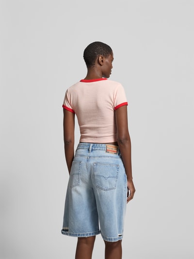 Frauenmodel trägt Cropped T-Shirt aus reiner Baumwolle von Kenzo in Rosa mit roten Details, Statement-Print, Rückenlänge 40 cm, Ganzkörperansicht Rückansicht.