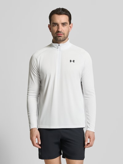 Męski model nosi Sweatshirt mit kurzem Reißverschluss und Logo-Print od Under Armour, prosty krój, stójka, nadruk z logo, długość tyłu 74 cm, długość rękawów 64 cm, całkowity widok z przodu.