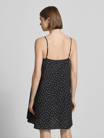 Frauenmodel trägt Minikleid im Allover-Look mit Spaghettiträgern von REVIEW aus Satin in A-Linie, Punktemuster, Ganzkörperansicht Rückansicht. Rückenlänge bei Größe S: 70 cm, Brustweite bei Größe S: 44 cm.
