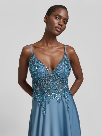 Frauenmodel trägt Abendkleid mit floralem Paillettenbesatz von Laona in Blau, semitransparente Optik, taillierte Passform, V-Ausschnitt, Spaghettiträger, Nahaufnahme Oberkörper.
