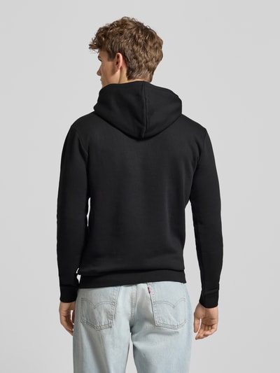 Männermodel trägt Regular Fit Hoodie aus Baumwoll-Mix Modell 'CERES' von Only & Sons, Optik: Unifarben Schwarz, Rückansicht Ganzkörperansicht.