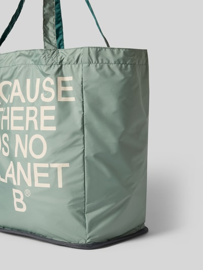 Produktfoto, Shopper mit Statement-Print Modell 'PACHO' von ECOALF in Hellgrün mit großem weißem Statement-Print, sichtbare Tragehenkel, rechteckige Form, glatte und leicht glänzende Oberfläche, Hauptfach offen, Maße bei Größe 1: Breite 31 cm, Länge 38 cm, Tiefe 22 cm, Länge Schulterriemen 64 cm.