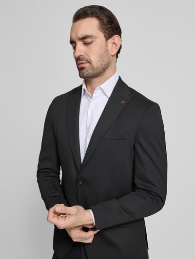 Męski model nosi Extra Slim Fit Anzug in unifarbenem Design von Roy Robson, mieszanka wiskozy z dodatkiem streczu, marynarka na 2 guziki, kołnierz z połami, kieszenie z patką, kanty, wpuszczane kieszenie, jednokolorowy, Ganzkörperansicht z przodu.