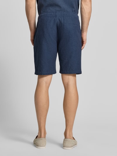 Mężczyzna nosi Shorts aus Leinen-Baumwoll-Mix mit elastischem Bund von MCNEAL w kolorze granatowym, krój regular fit, szerokość w rozmiarze M: 44 cm, długość wewnętrzna nogawki: 23 cm, z widocznym tunelem w pasie; widok całej sylwetki z tyłu