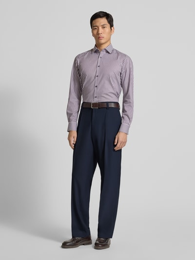 Männermodel trägt Regular Fit Anzughose mit Bügelfalten Modell 'FLIPS251X' von HUGO in Unifarben, Stretch-Twill, seitliche Eingrifftaschen, Gesäßtaschen, Knopf und verdeckter Reißverschluss, Ganzkörperansicht von vorne.