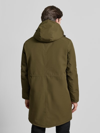 Męski model nosi Jacke mit Kapuze od MCNEAL w regularnym kroju, oliwkowy kolor, długość do uda, widok całej sylwetki od tyłu.