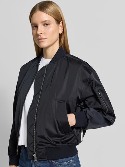 Vrouwenmodel draagt Regular Fit blouson met collegekraag van Marc O'Polo, look: effen, satijn, waterafstotend twill, steekzakken, ritssluiting, lange mouw, geribd, Ganzkörperansicht van voren.