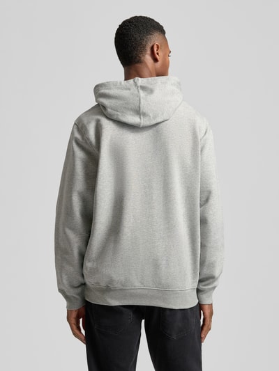Männermodel trägt Hoodie mit Logo und Känguru-Tasche von GAP aus Baumwoll-Mix in Grau, Regular Fit, Rückenansicht Ganzkörperansicht.
