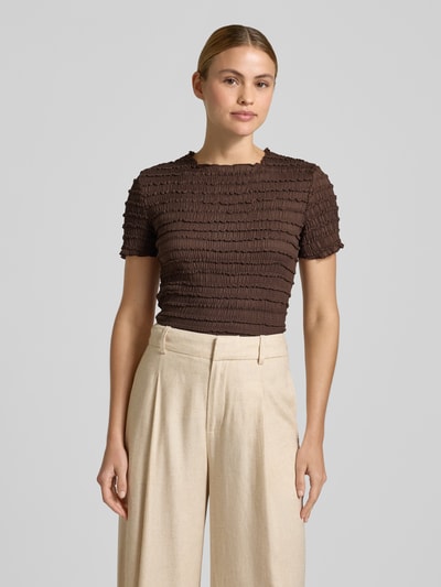 Modelka nosi damski t-shirt z fakturowanym wzorem i okrągłym dekoltem od Jake*s Collection, mieszanka materiałów z dodatkiem streczu, krój slim fit, długość tyłu w rozmiarze S: 48 cm, odcień brązowy, widok na górną część ciała z przodu.