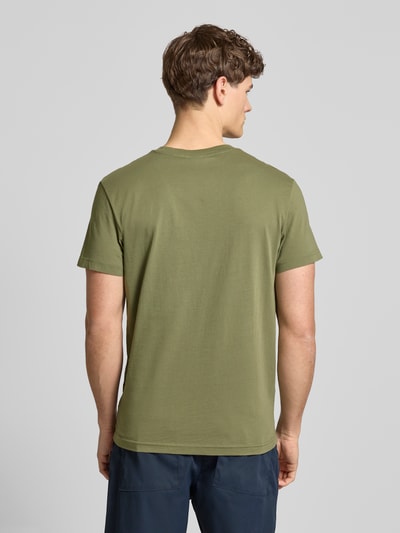 Männermodel trägt T-Shirt aus Baumwolle von G-Star Raw in olivgrün, gerader schnitt, ruggede textuur, label-stitching, ganzkörperansicht rückansicht.