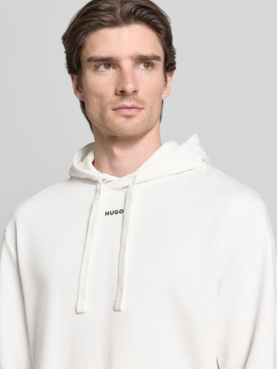 Männermodel trägt Regular Fit Hoodie aus reiner Baumwolle Modell 'DAPO' von HUGO, unifarben, Label-Schriftzug, Nahaufnahme Oberkörper