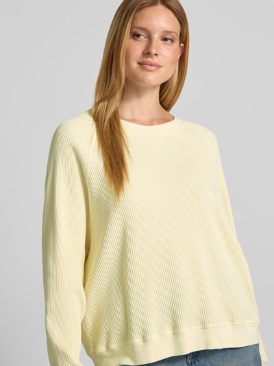 Vrouwenmodel draagt sweatshirt met structuurpatroon Model 'USCOW' van American Vintage, puur katoen, relaxed fit, ronde hals, ruglengte maat XS/S 64 cm, Nahaufnahme bovenlichaam.