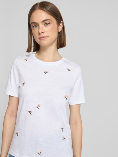 Frauenmodel trägt Regular Fit T-Shirt aus reiner Bio-Baumwolle Modell 'KETTY' von Only, weiß meliert, Motiv-Stitching, Nahaufnahme Oberkörper.