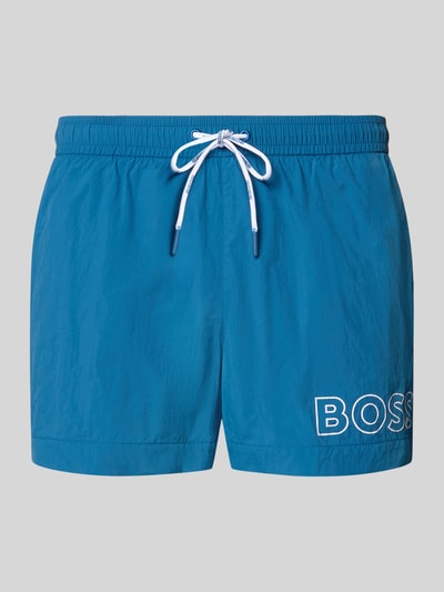Produktfoto, Regular Fit Badeshorts mit Label Print Modell 'MOONEYE' von BOSS, Optik: Unifarben in Blau, elastischer Bundabschluss mit Tunnelzug, seitliche Eingrifftaschen, glatte Textur