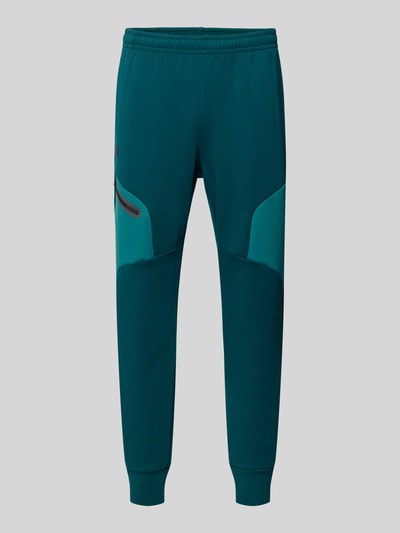 Produktfoto, Regular Fit Sweatpants mit Logo-Print Modell 'Unstoppable' von Under Armour, Herren Sweatpants im Elastischer-Material-Mix mit Baumwoll-Anteil, Beintasche mit Reißverschluss, elastischer Bund und Beinabschlüsse, Innenbeinlänge 73 cm, grün-blau, glatte Struktur