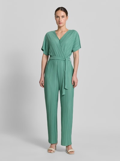 Vrouwenmodel draagt Jumpsuit met plissévouwen en strikceintuur model 'Pe44arl' van ZABAIONE in wikkellook met V-hals, getailleerd model, groene tint, zachte textuur, dames jumpsuit, totale lengte 145 cm, ruglengte 38 cm, borstwijdte 39 cm, binnenbeenlengte 69 cm, geheelvooraanzicht.