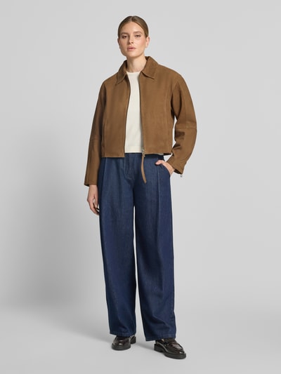 Frauenmodel trägt Lederjacke mit Zweiwege-Reißverschluss Modell 'SALERA' von YAS aus Ziegenleder, Regular Fit, Umlegekragen, Ganzkörperansicht von vorne.