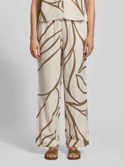 Frauenmodel trägt Stoffhose aus Viskose-Mix Modell 'PRISILLA' von Vila mit Leinen-Viskose-Anteil, Wide Leg, Eingrifftaschen und Tunnelzug, Natur- und Brauntöne, abstraktes Muster, Damen Stoffhose, Ganzkörperansicht von vorne.