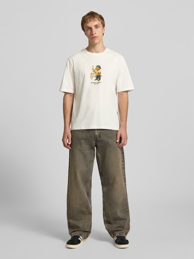 Männermodel trägt T-Shirt mit Motiv-Print von REVIEW in Weiß, reine Baumwolle, Regular Fit, Rundhalsausschnitt, Ganzkörperansicht von vorne.