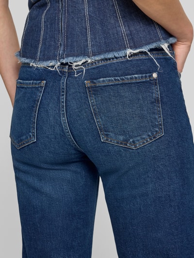 Frauenmodel trägt Jeans in verkürzter Passform mit Fransen von JOOP!, dunkelblauer Baumwoll-Mix mit Stretch-Anteil, Eingrifftaschen, Nahaufnahme Rückansicht.