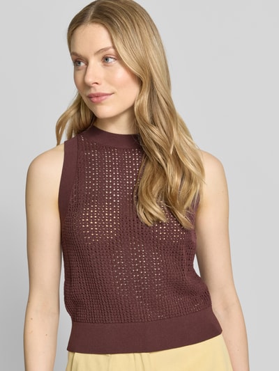 Frauenmodel trägt Slim Fit Top aus Viskose-Mix Modell 'FASSIA' von BOSS in Strickoptik, hochgeschlossen, ohne Ärmel, Materialverarbeitung: Strick, braune Farbe, strukturierte Oberfläche, Nahaufnahme Oberkörper.