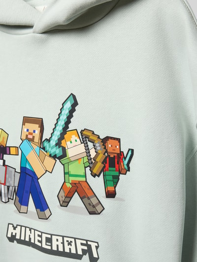 Produktfoto, Hoodie mit Kapuze von Mango aus Baumwoll-Mix, lockerer Schnitt, Kapuze, Motiv-Print Minecraft, gerippte Abschlüsse, auf hellem Stoff