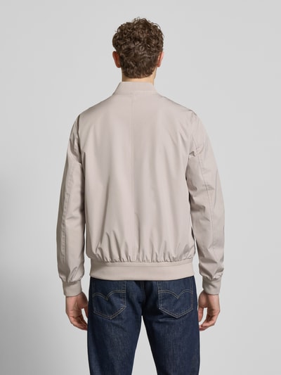 Männermodel trägt Regular Fit Jacke mit Stehkragen Modell 'Rapid' von CINQUE in Beige, elastische Abschlüsse, ganzkörperansicht rückansicht.