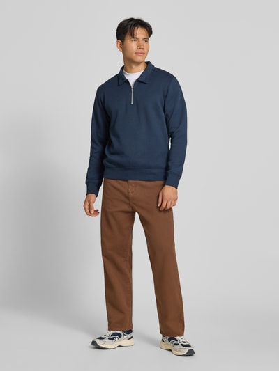 Męski model nosi Straight Fit Jeans aus reiner Baumwolle Modell 'ALEX ORIGINAL' von JACK & JONES, brązowy kolor, 5 kieszeni, zapięcie na guzik i zamek błyskawiczny, szerokość w rozmiarze 32/32: 43 cm, długość wewnętrzna nogawki: 73 cm, widok całej sylwetki z przodu.