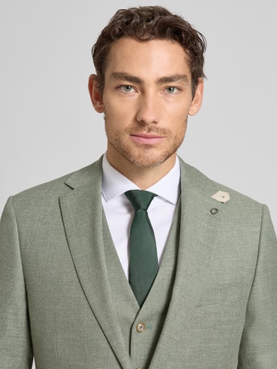 Männermodel trägt Modern Fit 2-Knopf-Sakko mit Pattentaschen Modell 'Ezzo' von DIGEL aus Material-Mix mit Viskose-Anteil, Nahaufnahme Oberkörper.