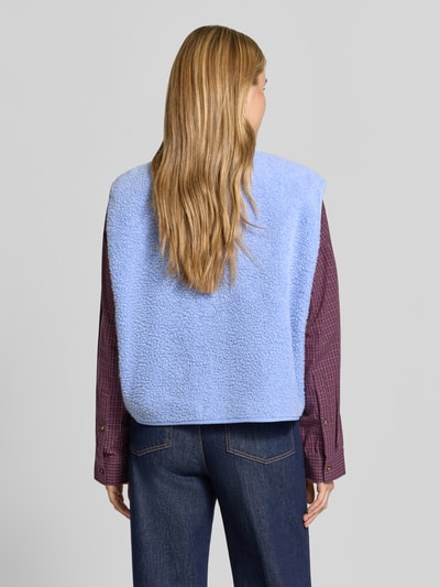 Frauenmodel trägt Relaxed Fit Weste aus Teddyfell Modell 'Hoktown' von American Vintage in Hellblau, Rückenansicht, Damen Weste, KI-modifiziertes Bild.