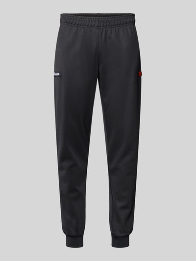 Produktfoto, spodnie dresowe Sweatpants mit elastischem Bund Modell 'BERTONI' von Ellesse, mieszanka bawełny, krój regular fit, detal z logo, długość wewnętrzna nogawki w rozmiarze M: 76 cm, kolor czarny, gładka struktura tkaniny