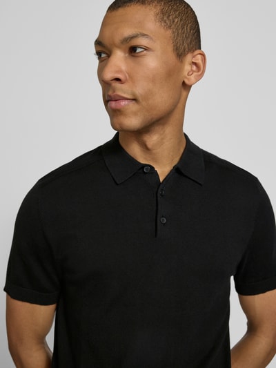Männermodel trägt Regular Fit Poloshirt aus reiner Baumwolle Modell 'BERG' von SELECTED HOMME, unifarben, Nahaufnahme Oberkörper.