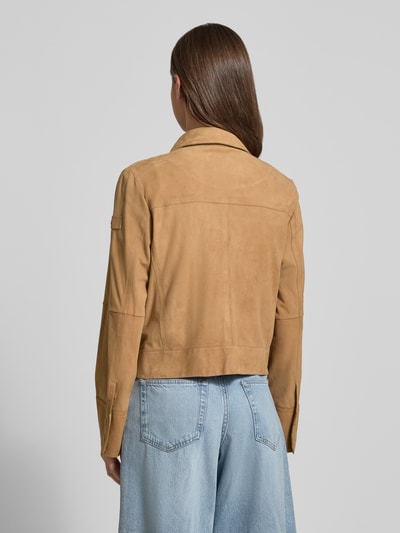 Frauenmodel trägt Lederjacke mit Pattentaschen Modell 'Era' von Peuterey in hellem Braun, glatte Textur, gerader Schnitt, Jeans, Ganzkörperansicht Rückansicht.
