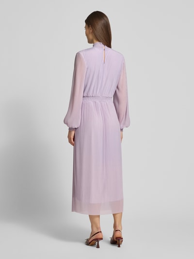 Modelka nosi Regular Fit Sukienka midi w plisowanym stylu Model 'Kate' od Guido Maria Kretschmer, fioletowa, stójka, podszewka, długie rękawy, długość tyłu w rozmiarze 36: 37 cm, szerokość w rozmiarze 36: 34 cm, długość rękawa w rozmiarze 36: 66 cm. Widok całej sylwetki od tyłu.