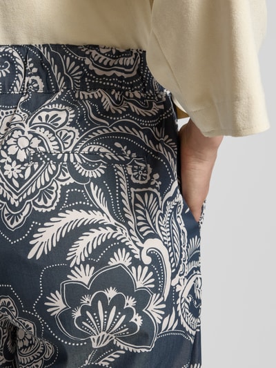 Frauenmodel trägt Wide Leg Hose aus Baumwoll-Mix Modell 'MAINE S' von Brax mit Optik: Allover-Muster, seitliche Eingrifftaschen, Nahaufnahme Hüfte.