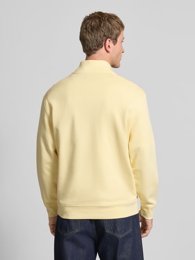 Männermodel trägt Sweatshirt mit Stehkragen und Reißverschluss von Calvin Klein Jeans in Gelb, reine Baumwolle, Regular-Fit, Rückenansicht.