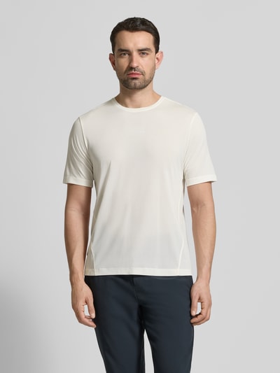 Männermodel trägt Funktionsshirt mit Rundhalsausschnitt und Logo von Salomon in Off-White, glatte Textur, Regular Fit, Ganzkörperansicht von vorne.