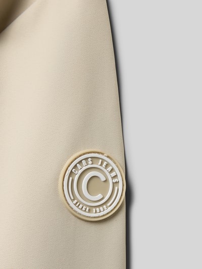 Detailopname, crèmekleurige stof met witte logo-applicatie Regular fit Jacke mit Logo-Applikation Modell 'Zinnia' van CARS JEANS, afneembare capuchon, steekzakken, opstaande kraag, ruglengte maat 140: 58 cm, schouderbreedte 36 cm, mouwlengte 55 cm