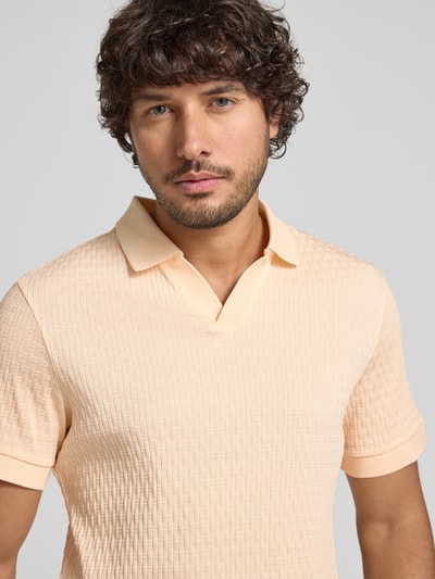 Männermodel trägt Regular Fit Poloshirt mit V-Ausschnitt Modell 'Rauljose' von JOOP! Collection aus reiner Baumwolle, Strukturmuster, Nahaufnahme Oberkörper