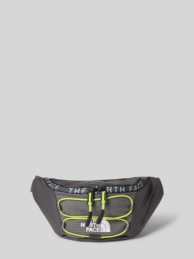 Produktfoto, schwarze Bauchtasche mit Label-Stitching Modell 'JESTER LUMBAR' von The North Face, Reißverschluss, neongelbe Akzente, größenverstellbar, robustes Material, Maße 26x17x10 cm, Hauptfach, längenverstellbarer Schulterriemen