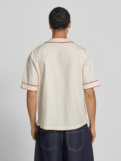 Männermodel trägt Relaxed Fit Freizeithemd mit Logo von REVIEW aus Reine Baumwolle in Creme mit roten Akzenten, Rückenlänge 74 cm, Schulterbreite 50 cm, Ärmellänge 29 cm, Ganzkörperansicht Rückansicht.