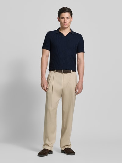 Męski model nosi Regular Fit Strick-Poloshirt Modell 'TONO' od CINQUE, bawełniany miks, strukturalny wzór, V-dekolt, długość tyłu w rozmiarze M: 67 cm, krój regular fit, widok całej sylwetki z przodu