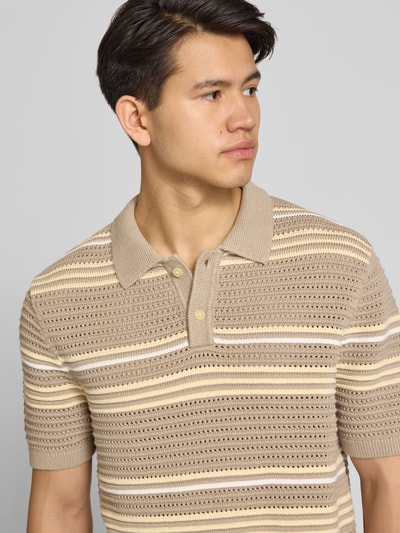 Männermodel trägt Relaxed Fit Poloshirt aus reiner Baumwolle Modell 'LAGUNA' von Levi's®, gestreift, Strickoptik, Nahaufnahme Oberkörper.