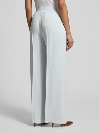 Frauenmodel trägt Weite Hose aus reiner Viskose Modell 'TIANA10' von BOSS, unifarben, Wide Leg, elastischer Bund, Rückansicht Ganzkörperansicht.