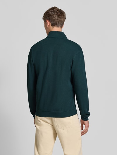 Męski model nosi Regular Fit Jacke aus Baumwoll-Mix Modell 'SELANIK' von LERROS, kolor ciemnozielony, widok z tyłu, kontekst: kurtka męska z bawełnianej mieszanki, krój regular fit, zamek błyskawiczny, boczne kieszenie, długość tyłu w rozmiarze M: 69 cm, długość rękawa w rozmiarze M: 65 cm. Ganzkörperansicht Rückansicht